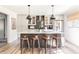 Renovated kitchen features an island, stainless steel appliances, and stylish pendant lighting at 7350 Ono Rd, Palmetto, GA 30268