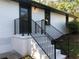 White brick exterior with a black railing and steps leading to the front door at 7350 Ono Rd, Palmetto, GA 30268