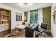 Home office with a desk, seating area, and built-in shelving at 7350 Ono Rd, Palmetto, GA 30268