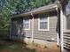 Side view of house showcasing its beige vinyl siding, windows and gutters at 115 Elberta St, Mcdonough, GA 30253