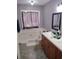 Bathroom with bathtub, vanity, and neutral colors at 115 Elberta St, Mcdonough, GA 30253