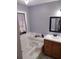 Bathroom with soaking tub and wood vanity at 115 Elberta St, Mcdonough, GA 30253