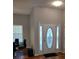 Bright entryway with an oval glass design front door and hardwood floors at 115 Elberta St, Mcdonough, GA 30253