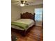 Primary bedroom with king-size bed and wood-look floors at 115 Elberta St, Mcdonough, GA 30253