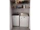Well-lit laundry room with washer, dryer, and ample storage at 115 Elberta St, Mcdonough, GA 30253