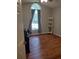 Bright bedroom with wood-look floors and an arched window at 115 Elberta St, Mcdonough, GA 30253