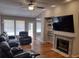 Spacious living room with fireplace and large TV at 115 Elberta St, Mcdonough, GA 30253