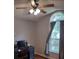 Bedroom with wood-look floors, ceiling fan, and large window at 115 Elberta St, Mcdonough, GA 30253