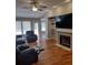 Relaxing living room featuring hardwood floors and a fireplace at 115 Elberta St, Mcdonough, GA 30253