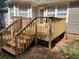Wooden deck with stairs leading to the ground and partially visible house exterior at 115 Elberta St, Mcdonough, GA 30253