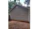 Side view of house with gray vinyl siding and a small vent at 115 Elberta St, Mcdonough, GA 30253