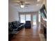Bright living room with hardwood floors and patio access at 115 Elberta St, Mcdonough, GA 30253