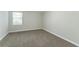 Bright basement bedroom with a window and neutral carpeting at 8596 Timberlane Dr, Douglasville, GA 30134