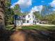 White farmhouse with a side view showcasing the landscaping and yard at 3563 Denby Dr, Snellville, GA 30039
