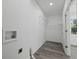 Bright laundry room with vinyl flooring and ample shelving at 3563 Denby Dr, Snellville, GA 30039
