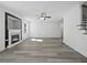 Living room with a fireplace, gray vinyl flooring, and a ceiling fan at 3563 Denby Dr, Snellville, GA 30039