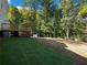 Wooded backyard with partially grassy area at 3563 Denby Dr, Snellville, GA 30039