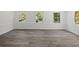 Sunlit living room with gray flooring and large windows offering natural light at 3563 Denby Dr, Snellville, GA 30039