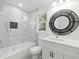 Updated bathroom with a white vanity, bathtub, and stylish mirror at 3563 Denby Dr, Snellville, GA 30039