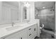 Elegant bathroom with double vanity, marble shower, and modern fixtures at 3563 Denby Dr, Snellville, GA 30039