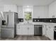Modern kitchen with stainless steel appliances and white shaker cabinets at 3563 Denby Dr, Snellville, GA 30039
