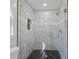 Large walk-in shower with marble tile and a frameless glass enclosure at 3563 Denby Dr, Snellville, GA 30039