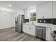 Updated kitchen, featuring stainless steel appliances and white cabinets at 3563 Denby Dr, Snellville, GA 30039