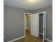 Bedroom with gray walls, wood-look flooring, and access to other rooms at 890 Mcwilliams Se Rd, Atlanta, GA 30315