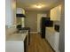 Galley kitchen with white cabinets and black appliances at 890 Mcwilliams Se Rd, Atlanta, GA 30315