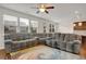 Open living room with a large sectional sofa and view into kitchen area at 5820 Keystone Pt, Lithonia, GA 30058