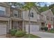 Brick front townhouse with 2-car garage and landscaped yard at 5820 Keystone Pt, Lithonia, GA 30058