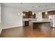 Open kitchen with a large island, stainless steel appliances, and dark brown cabinets at 5820 Keystone Pt, Lithonia, GA 30058