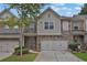 Two-story townhome with two-car garage and landscaping at 5820 Keystone Pt, Lithonia, GA 30058