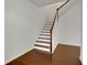 Elegant staircase with hardwood steps and white railings at 5820 Keystone Pt, Lithonia, GA 30058