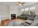 Living room with a fireplace, built-in shelving, and large sectional sofa at 5820 Keystone Pt, Lithonia, GA 30058