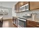 Modern kitchen with stainless steel appliances and granite counters at 5820 Keystone Pt, Lithonia, GA 30058