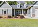 House entrance with stone accents, a covered porch, and landscaping at 1108 Red Bud Cir, Villa Rica, GA 30180