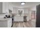 Updated kitchen with white cabinets, granite countertops, and stainless steel appliances at 3745 Londonderry Ct, Stonecrest, GA 30038