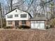 Two-story house with brick and white siding, attached garage, and mature trees at 3745 Londonderry Ct, Stonecrest, GA 30038