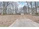 Two-story house with brick and white siding, a driveway, and trees surrounding the property at 3745 Londonderry Ct, Stonecrest, GA 30038