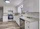 Renovated kitchen with white cabinets, granite countertops, and stainless steel appliances at 3745 Londonderry Ct, Stonecrest, GA 30038