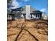 Rear view of a charming two-story house with gray siding, a brick staircase, and a spacious backyard at 20 Wisteria Blvd, Covington, GA 30016