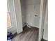 Laundry room with built-in shelving and vinyl flooring at 20 Wisteria Blvd, Covington, GA 30016