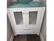 White bathroom vanity with glass top and light green sink at 20 Wisteria Blvd, Covington, GA 30016
