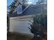Two-car garage with white door and dormer window at 20 Wisteria Blvd, Covington, GA 30016