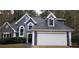 Two-story home with gray siding, white trim, and a two-car garage at 20 Wisteria Blvd, Covington, GA 30016