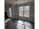 Sunlit dining area with wood-look floors, French doors, and windows offering wooded views at 20 Wisteria Blvd, Covington, GA 30016