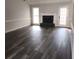 Spacious living room featuring hardwood floors, a fireplace, and large windows at 20 Wisteria Blvd, Covington, GA 30016