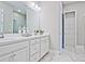 Bright bathroom with dual vanity and marble tile flooring at 7125 Winderlea Ln, Cumming, GA 30040