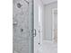 Modern shower with marble tile walls and glass enclosure at 7125 Winderlea Ln, Cumming, GA 30040